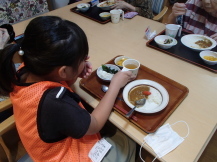 子どもたちがお昼にカレーを食べている写真