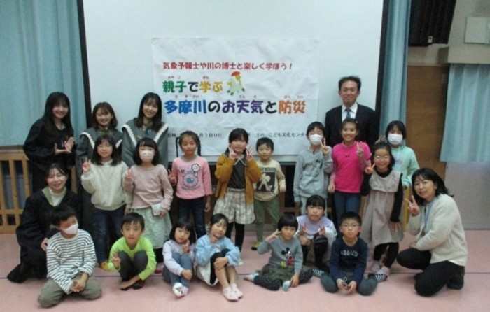 参加した子どもたちが講師である大学教授の知花先生や気象予報士の澤井明子さんと一緒に記念撮影した集合写真